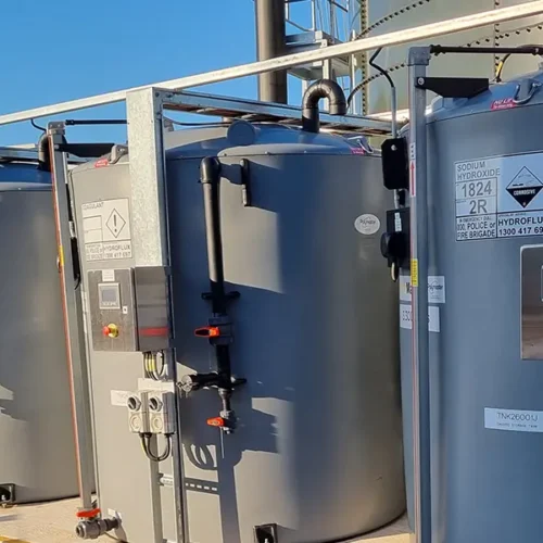 Intermediate bulk storage cabinets with integrated dosing pumps and secure fill stations